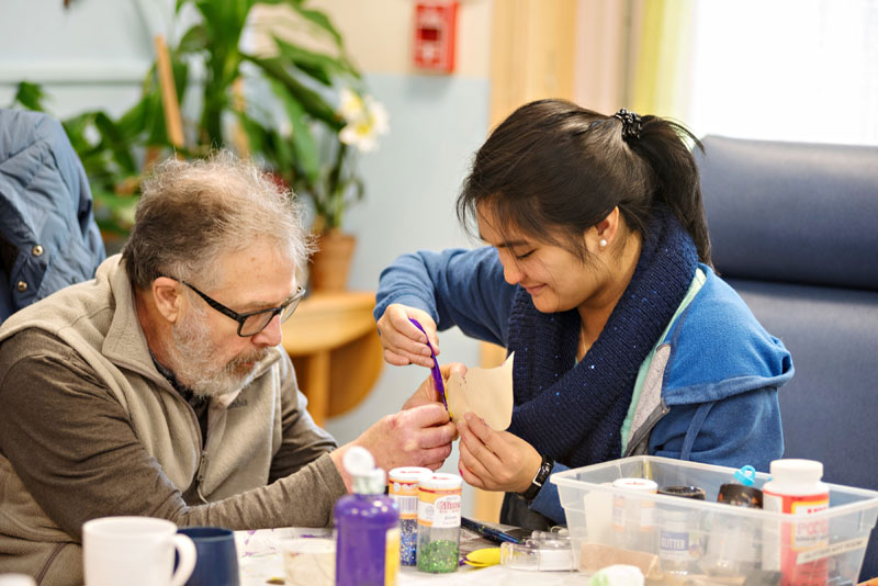 Patient and therapist making crafts